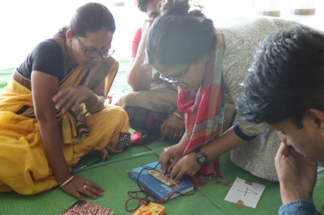 Resource person Tuba helping out the teachers in checking the resistance from the multimeter.